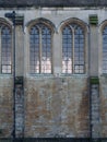 Close-up of exterior stone wall and stained glass windows in the Great Hall of Eltham Palace, England.