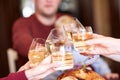 Close-up family clinking glasses on Thanksgiving on a table background. Cheers with champagne. Celebration concept. Royalty Free Stock Photo