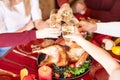 Close-up family clinking glasses on Thanksgiving on a table background. Cheers with champagne. Celebration concept. Royalty Free Stock Photo