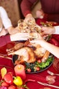 Close-up family clinking glasses on Thanksgiving on a table background. Cheers with champagne. Celebration concept. Royalty Free Stock Photo