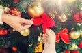 Close up of family decorating christmas tree Royalty Free Stock Photo
