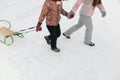 Close up of family with green and brown sleigh Royalty Free Stock Photo