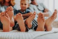 Close up family three pairs of feet in bed Royalty Free Stock Photo