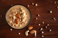 Close up of a famous Bengali dessert `Nolen Gurer Chanar Payesh` or Milk pudding of cottage cheese in a black bowl. Top-down view