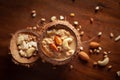 Close up of a famous Bengali dessert `Nolen Gurer Chanar Payesh` or Milk pudding of cottage cheese in Coconut shell. Top-down