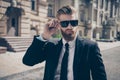 Close up of a famous guy in formal wear and sunglasses outdoors. Royalty Free Stock Photo