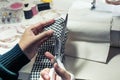 Close up fashion designer cutting cloth with equipment