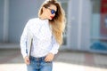 Close up fashion portrait of attractive woman in jeans with long hair.Girl in jeans suit.Charming lady with new denim