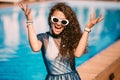 Close up fashion portrait of sensual smiling beauty brunette woman posing in swimming pool, relaxing enjoy her summer vacation Royalty Free Stock Photo