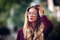 Close up fashion street stile portrait of pretty girl in fall casual outfit Beautiful blond posing outdoor. Royalty Free Stock Photo