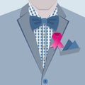 Close up of fashionable male in blue suit and pink ribbon pin on collar