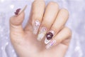 Close up Fashionista woman acrylic fingernail painting beautiful white color gel nail art decorated with cute 3D rose flower