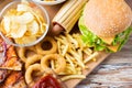 Close up of fast food snacks on wooden table Royalty Free Stock Photo