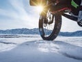 Close-up of a fatbike wheel, rolling on a frozen mountain lake