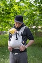 father carrying his child in a baby sling