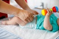 Close-up of father changing diaper of his newborn baby daughter. Royalty Free Stock Photo