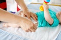 Close-up of father changing diaper of his newborn baby daughter. Royalty Free Stock Photo