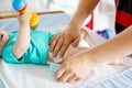 Close-up of father changing diaper of his newborn baby daughter. Royalty Free Stock Photo