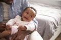 Close Up Of Father Holding Baby Daughter In Nursery