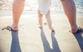 Close up of father and little baby feet on beach Royalty Free Stock Photo