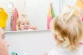 Close up father and little toddler daughter brushing her teeth and looking in the mirror in the bathroom. Reflection in the mirror Royalty Free Stock Photo