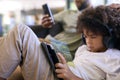Close Up Of Father With Mobile Phone And Son Playing A Game On Digital Tablet With Headphones At Home Royalty Free Stock Photo
