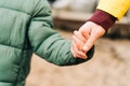 Close up Father and son stand on the shore of the lake and hold hands. Happy family with child kid boy playing and Royalty Free Stock Photo