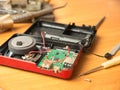 Close-up of a faulty radio receiver and a tool for repairing it. Soldering iron, screwdriver, motherboard, equipment repair.Select Royalty Free Stock Photo