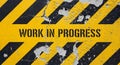 Work in Progress stencil on damaged caution sign Royalty Free Stock Photo