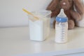 Close up of a feeding bottle with baby formula milk on white table Royalty Free Stock Photo