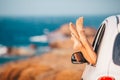 Closeup of little girl feet showing from car window Royalty Free Stock Photo