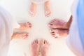 Close-up of the feet of family on the white sandy beach Royalty Free Stock Photo