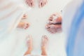 Close-up of the feet of family on the white sandy beach Royalty Free Stock Photo