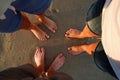 Close-up of the feet of family on the white sandy beach Royalty Free Stock Photo