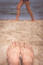 Mens feet on the beach Royalty Free Stock Photo