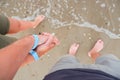Close-up of the feet of man and woman on the white sandy beach Royalty Free Stock Photo