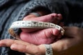 Close-up of the feet of a newborn baby on the palm of a mother Royalty Free Stock Photo