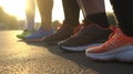 Close-up of feet of people in sneakers, standing on asphalt, in sunlight, at sunset