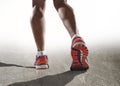 Close up feet with running shoes and female strong athletic legs of sport woman jogging Royalty Free Stock Photo