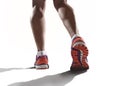 Close up feet with running shoes and female strong athletic legs of sport woman jogging