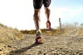 Close up feet with running shoes and strong athletic legs of sport man jogging in fitness training workout Royalty Free Stock Photo