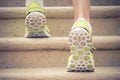 Close up of feet with sneakers climbing up the stairs