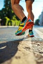 Close-up of feet in sneakers running. Low point of view. Colorful sparkling tones