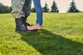 Close up feet of soldier and daughter.