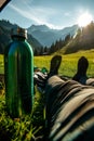 Close up of feet in a tent, a woman lying inside a green popup camping tent with a view of a grassy mountain landscape Royalty Free Stock Photo