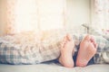 Close up feet of women sleeping on bed in Morning