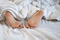 Close up feet of young child sleeping on bed Royalty Free Stock Photo