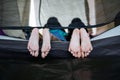 Close up on feets of two children while lying down and playing together in tent on campsite. Royalty Free Stock Photo