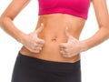 Close up of female abs and hands showing thumbs up Royalty Free Stock Photo