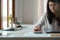 Close up of female accountant or banker making calculations. Savings, asian woman working for finances and economy Royalty Free Stock Photo